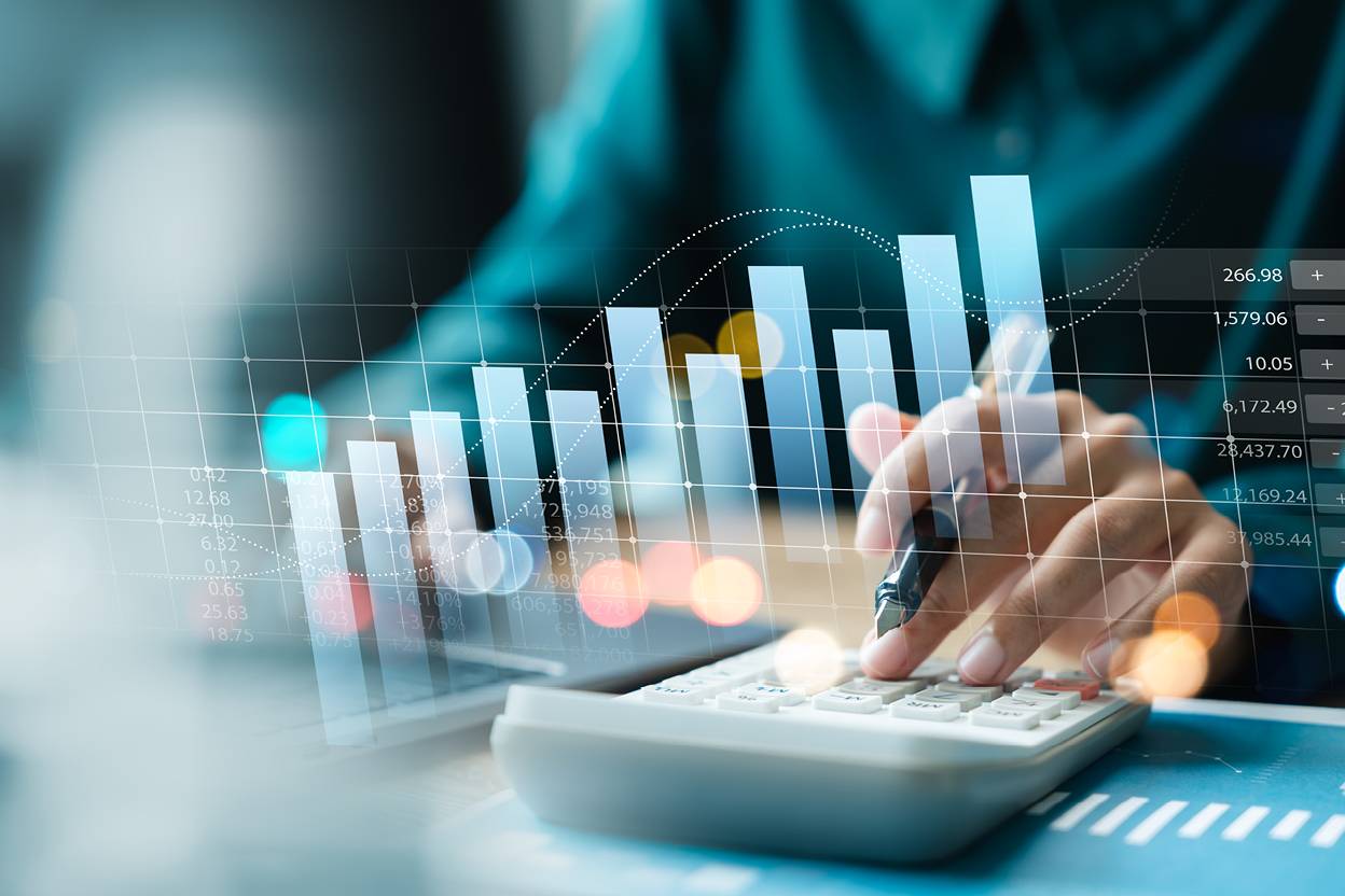 Person typing on calculator