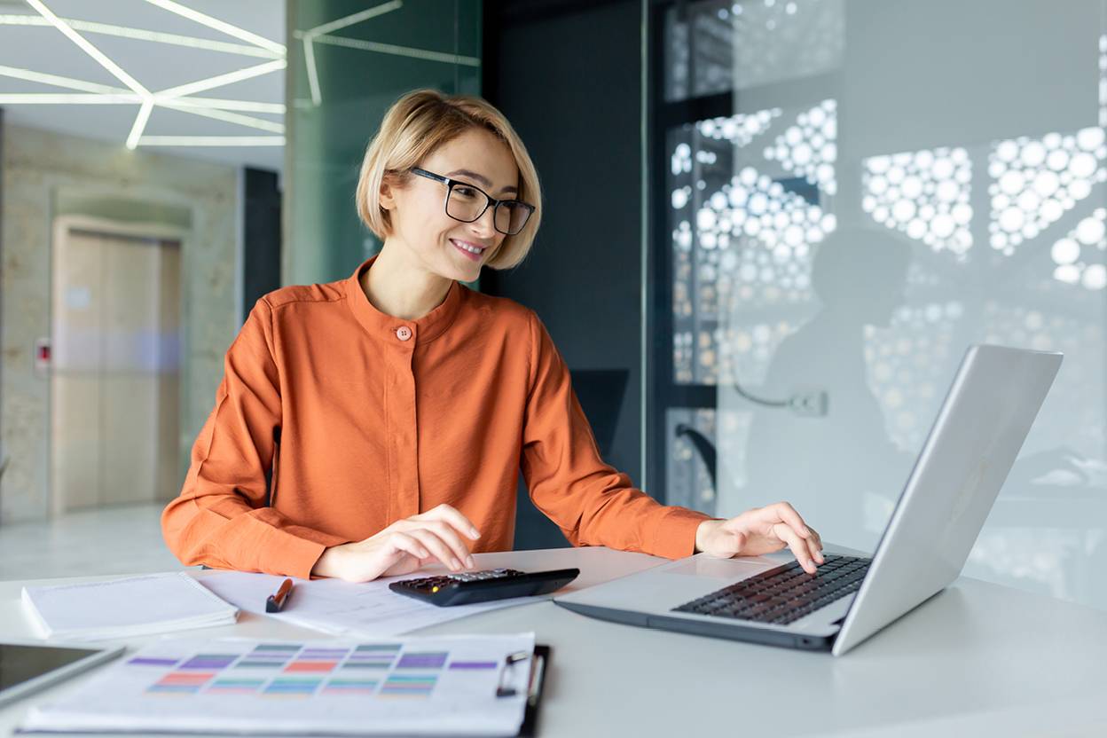 Person sitting on laptop smiling